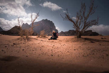 woman in the desert. woman under the trees in the desert