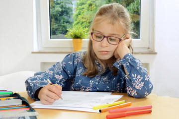 Little girl does not feel like doing homework or studying for school