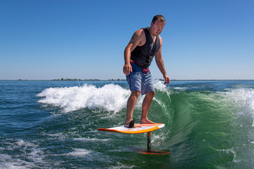 A wake surfer riding a foil board.