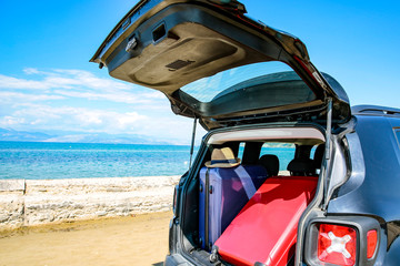 Summer car on a beautiful sunny sandy beach view.
