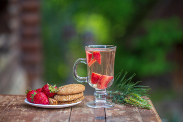 Herbal tea with strawberries on the table, close up. The concept of a healthy lifestyle.
