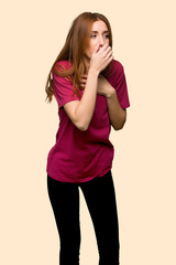 Young redhead girl is suffering with cough and feeling bad on isolated yellow background