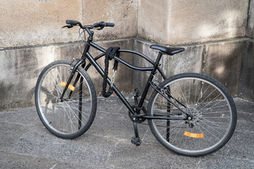 Fototapeta na wymiar Locked bicycle parked on the street