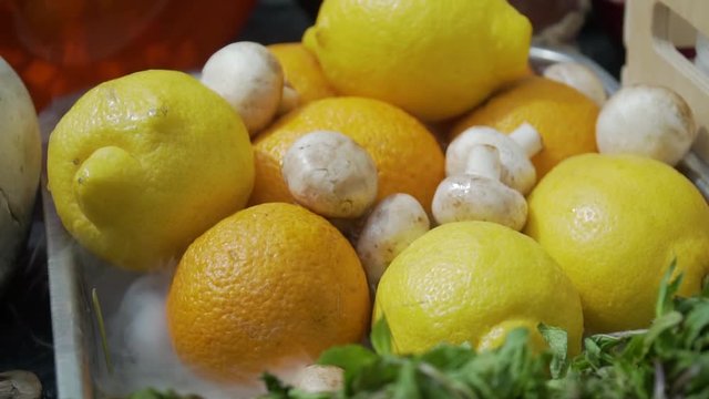 oranges, lemons, champignons and mint on a tray