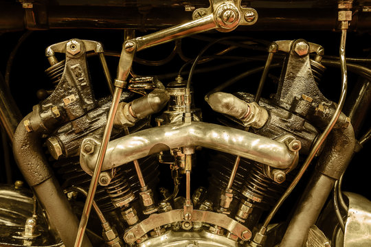 Sepia toned close-up view of a vintage motorcycle engine