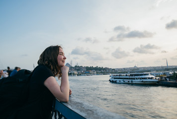 Tourist girl on the background of the sea and the city view