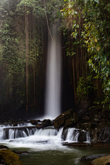 Waterfall landscape. Beautiful hidden Sumampan waterfall in tropical rainforest in Bali near Ubud. Slow shutter speed, motion photography.