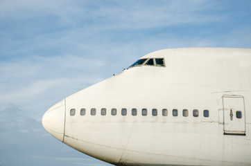 The head's airplane on the runway ready to start with the blue sky for background.