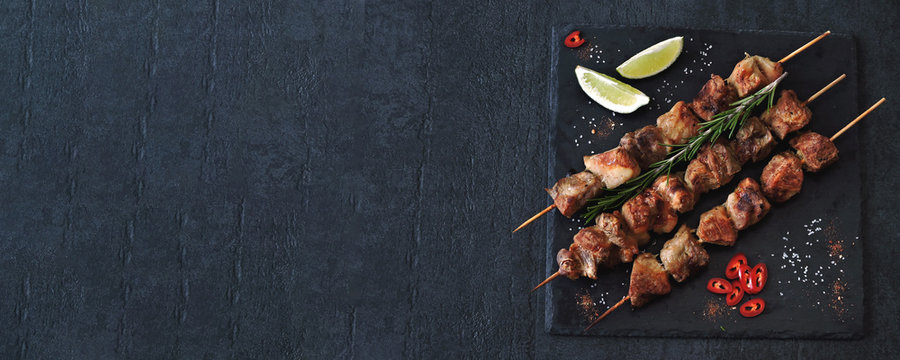 Delicious kebabs with spices. Kebab on wooden sticks.
