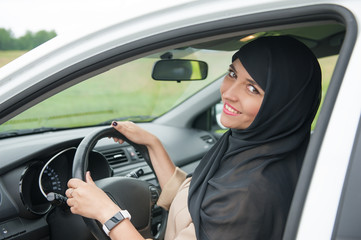 Beautiful arab muslim woman driving car