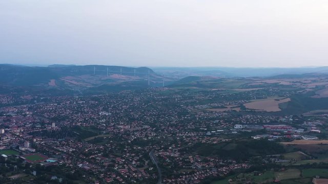 Aerial cloudy sunset over Millau with paragliders Averyon France viaduct