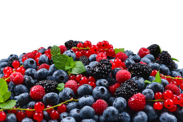 Blackberry, raspberry, blueberry,  red currant and mint background. Isolated on white. Copy space.