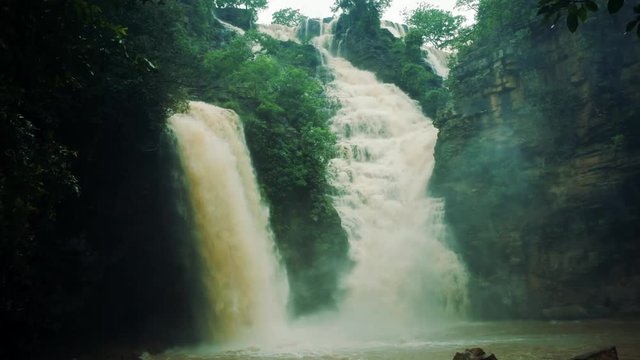 a Locked shot of Tirathgarh Water Falls of India. Powerful water rushing over a steep drop into a water mass.