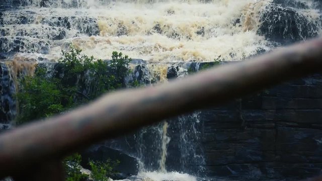 a Locked shot of The Chitrakote Falls: Niagara falls of India. Powerful water rushing over a steep drop into a water mass.