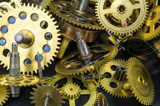 A variety of gears from the bronze clock work as a background.