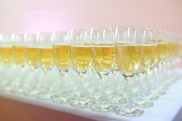 Champagne is poured into glasses before the event