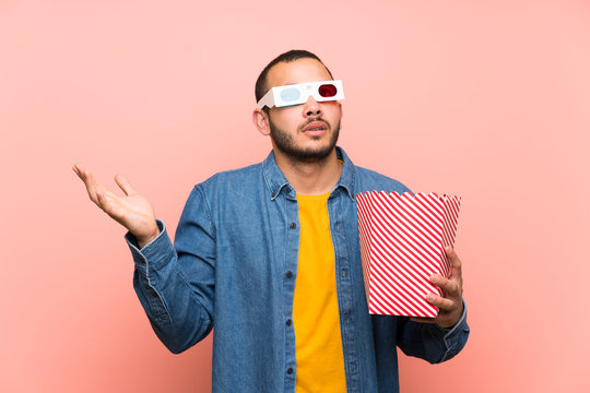 Colombian man with popcorns unhappy and frustrated with something. Negative facial expression