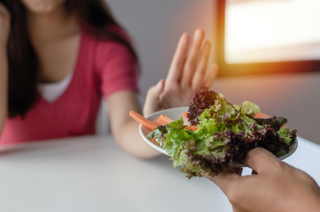 I don't like eating vegetables. unhappy young pretty woman slim body refuse to eat fresh vegetables...