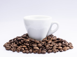 cup of coffee with beans on white background