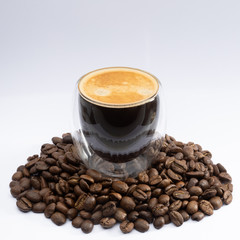 cup of espresso coffee with beans on white background