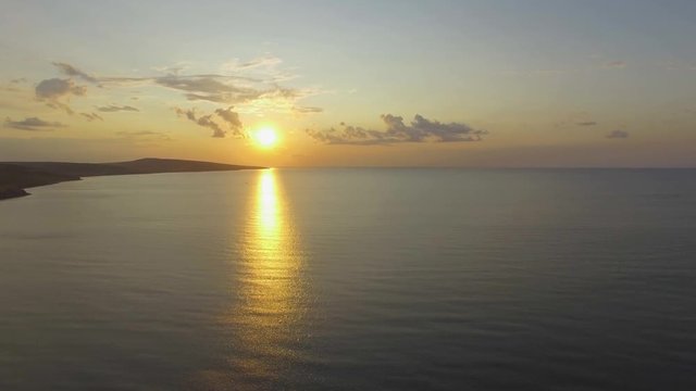  AERIAL: Landscape of sea coast at sunset. Sea ​​bay near island at sunset, aerial video