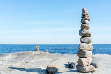 Stacked Rocks balancing, stacking with precision. Stone tower on shore. Copy space.