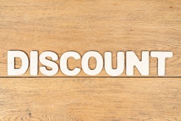 word discount of wooden letters on table