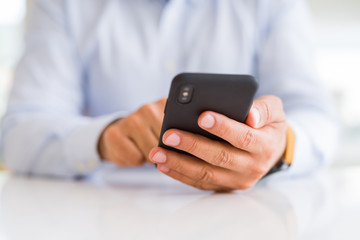 Close up of business man hands using smarpthone