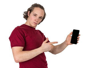 Handsome young man in t-shirt holding blank screen smartphone over white background