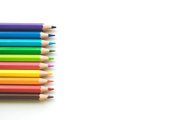 Rows of Color pencils on white paper background, copy space. Office supplies, back to school.