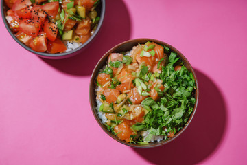 Poke bowl with marinated salmon and vegetable salad on rice