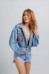 Fashion portrait of beautiful young woman with denim dress