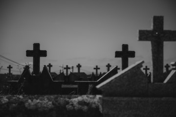 Dark crosses in the tombs of a cemetery that give a sad and spooky feeling