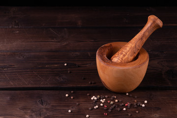 wooden mortar with pepper, low key, olive wood, rustic