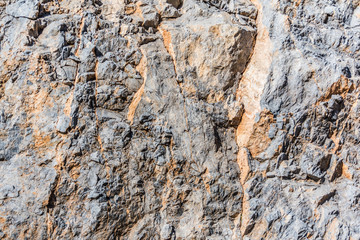 background and texture of mountain layers and cracks in sedimentary rock on cliff face. Cliff of rock mountain.