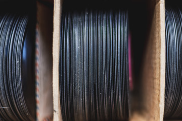 Macro close-up of vinyl records in cardboard box without their covers
