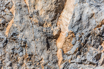 background and texture of mountain layers and cracks in sedimentary rock on cliff face. Cliff of rock mountain.