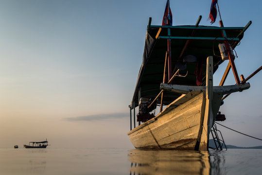 A fishing boat moored at the tranquil waters of the Tui Beach in Koh Rong Island, Cambodia.