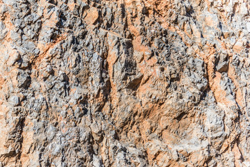 background and texture of mountain layers and cracks in sedimentary rock on cliff face. Cliff of rock mountain.