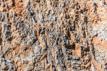 background and texture of mountain layers and cracks in sedimentary rock on cliff face. Cliff of rock mountain.