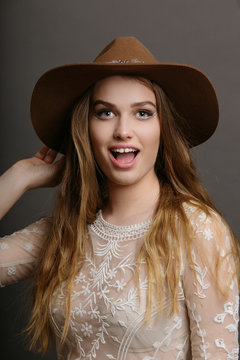 Portrait of young smiling woman wearing hat