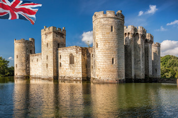 Historic Bodiam Castle with flag of England in East Sussex, United Kingdom