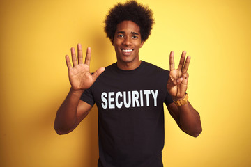 American safeguard man with afro hair wearing security uniform over isolated yellow background...
