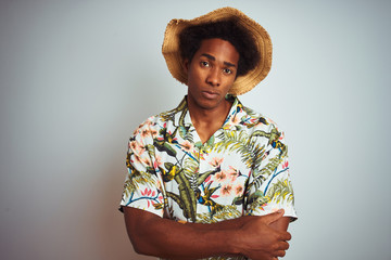 Afro american man on vacation wearing summer shirt and hat over isolated white background skeptic...