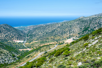 Top view from the mountains to the village of Malia, roads and the nearby villages of the field and the Aegean Sea. Crete, Greece
