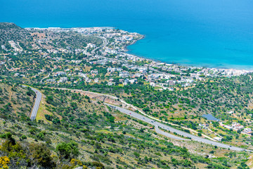 Fototapeta premium Top view from the mountains to the village of Malia, roads and the nearby villages of the field and the Aegean Sea. Crete, Greece