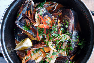 Mussels with greens, lemons and tomatoes