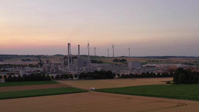 Southeastern aerial view of the industrial area of Brilon. Pan from right to left in the setting sun. Very detailed.