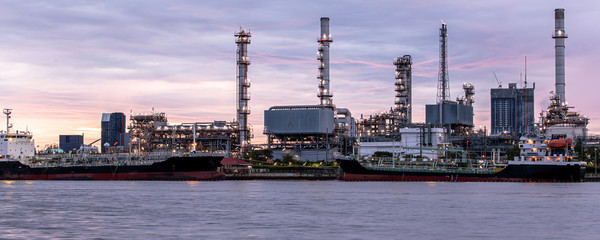 Banner of petroleum oil refinery plant beside river in twilight time. Crude Oil Process machinery