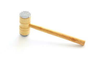 wooden hammer beat meat on a white background, isolated